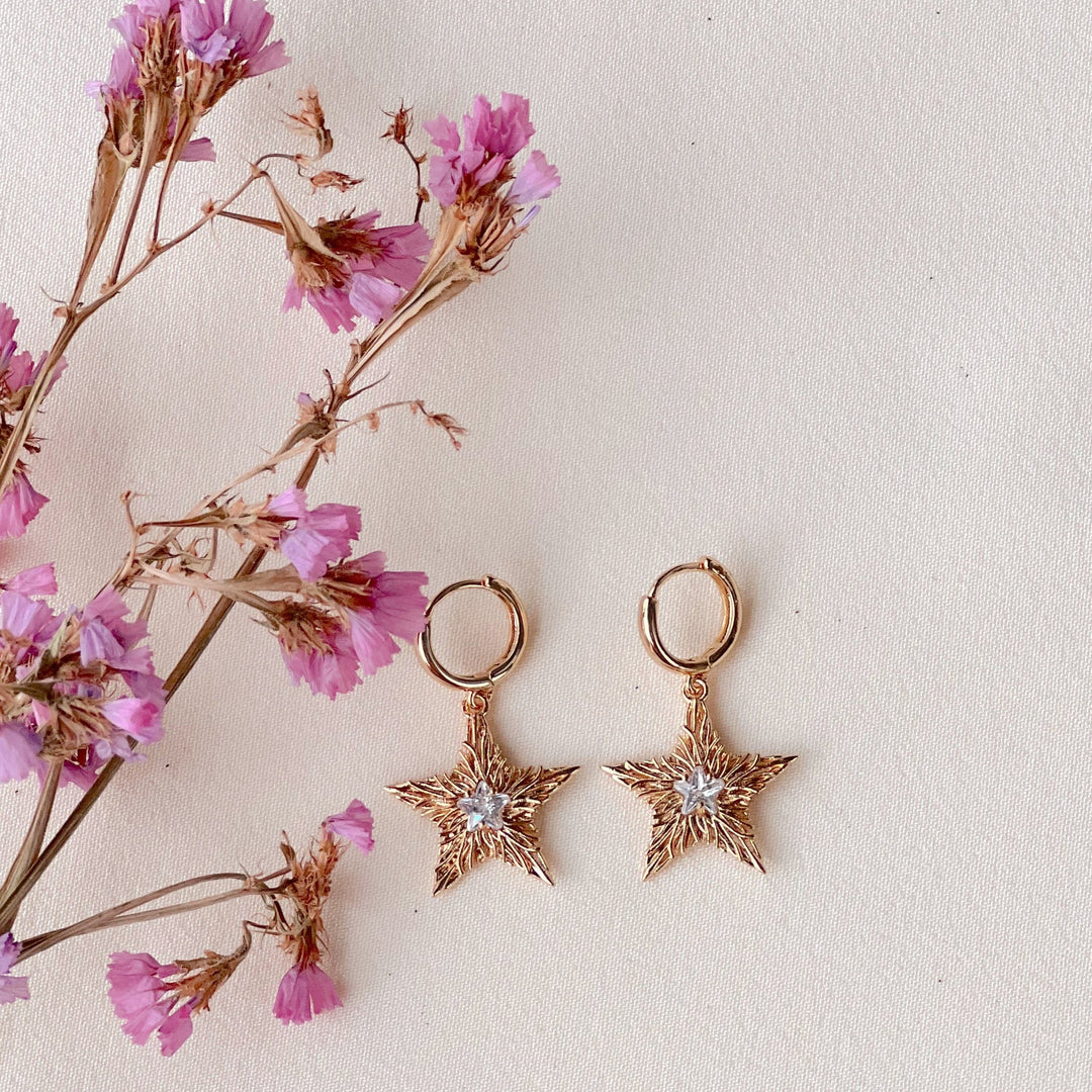 Asteri Hoops Dangle Earrings - Golden Star Charms with Crystal Centers and Rhodium Plating